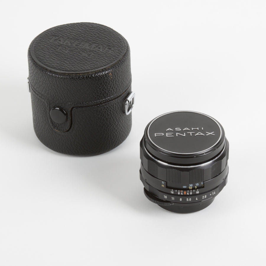 Asahi Pentax camera lens with black case and lens caps