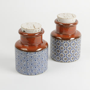 Set of two Japanese spice jugs with corks, rust glaze blue geometric pattern base