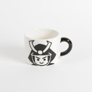 White coffee mug with black handle and warrior graphic face