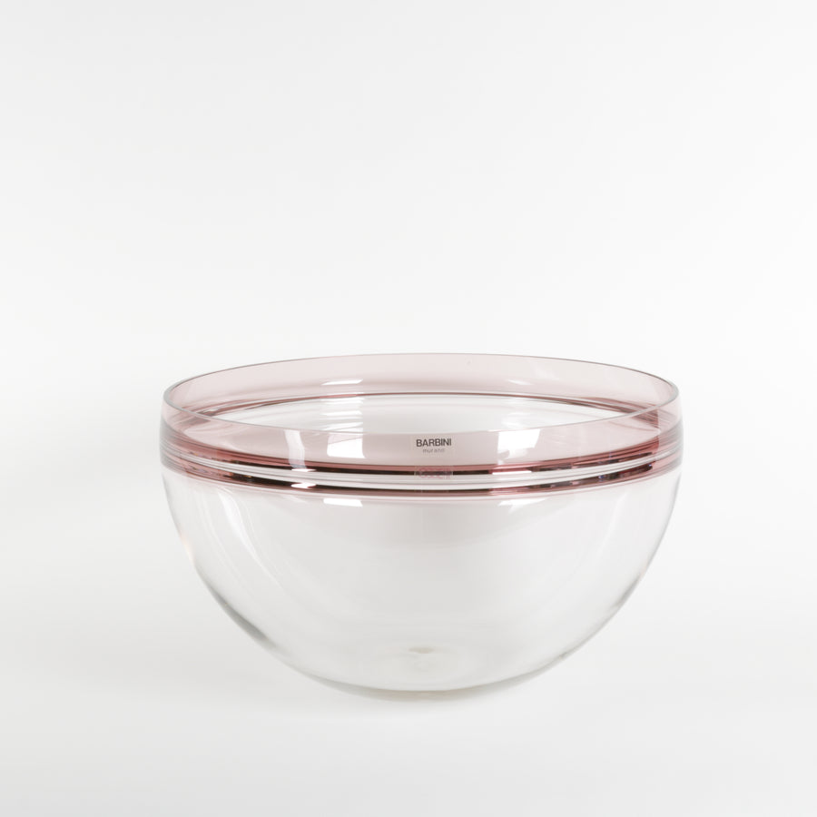 Clear glass bowl with mauve rim on a white background