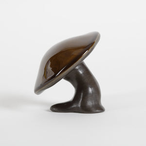 ceramic brown mushroom against a white background