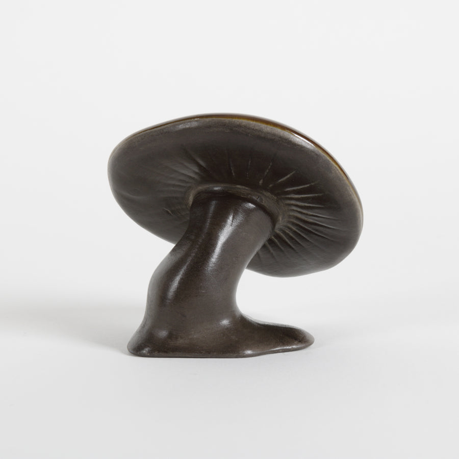 ceramic brown mushroom against a white background