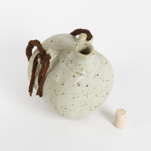 Speckle glazed stoneware flask with cork and braided leather strap