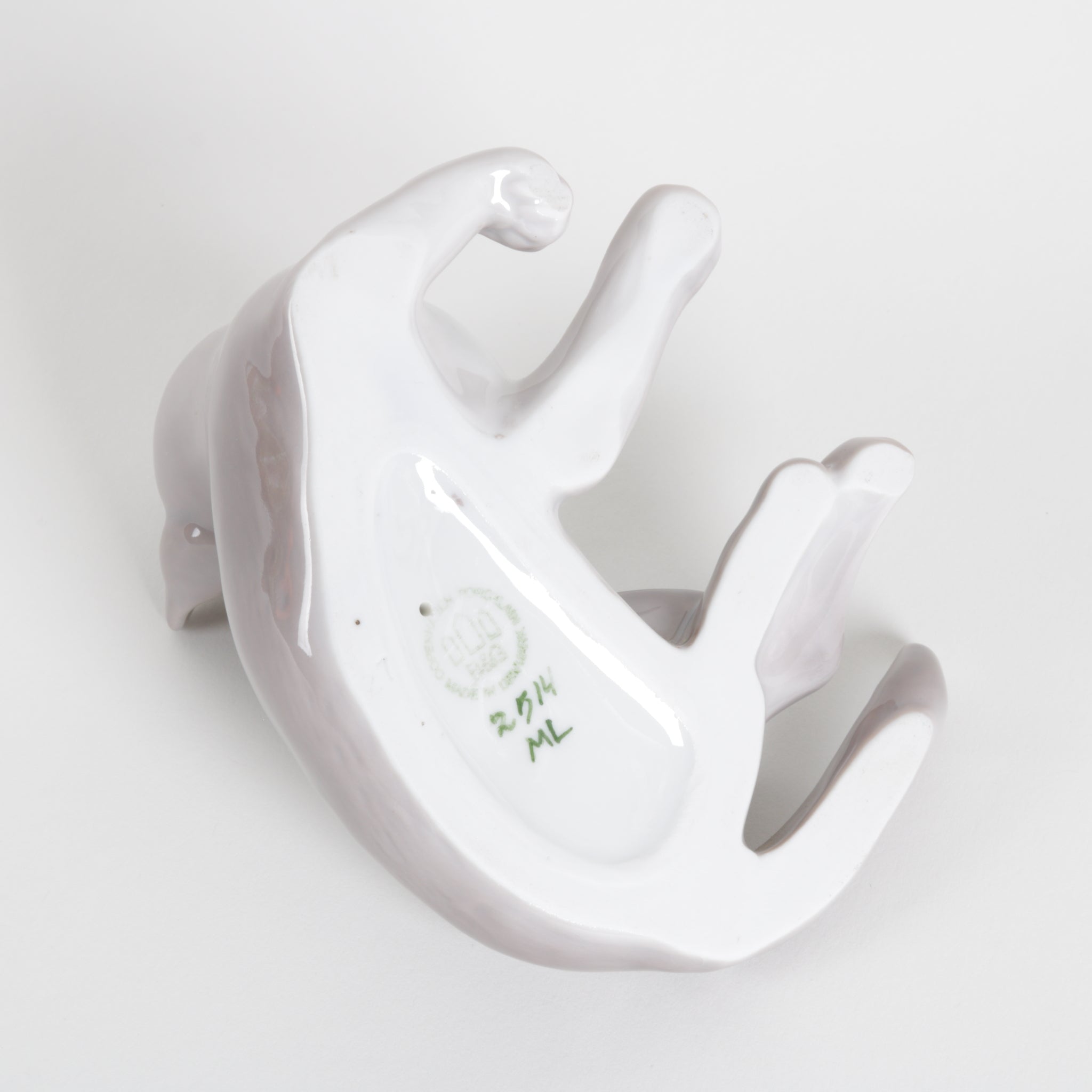 A glossy white ceramic cat figurine photographed on a clean white background. The underside shows a green hand-painted size marking of '2514'.