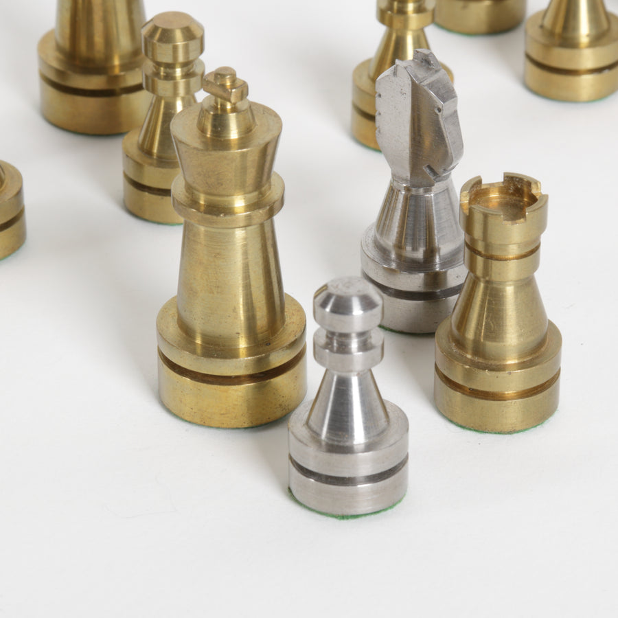 Set of gold and silver chess pieces on a white background
