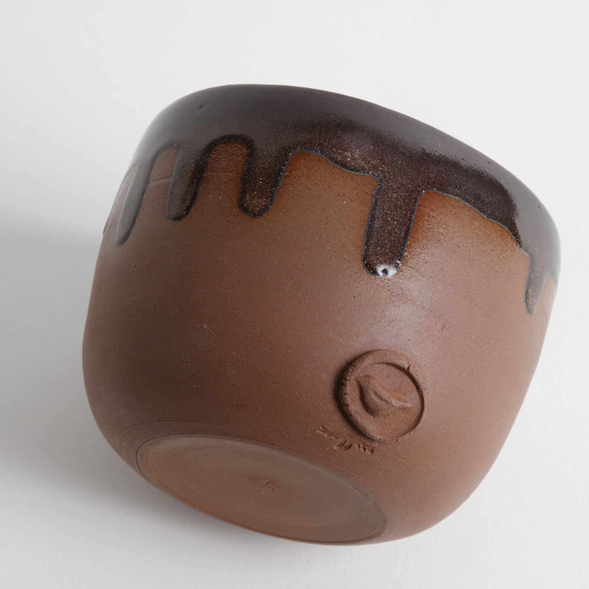 Brown ceramic cup with bird artists stamp 