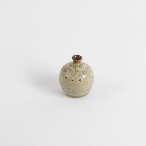 Studio pottery tiny vase with speckled cream and earth tone glaze