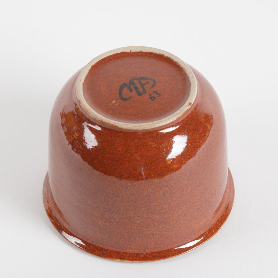 Dark orange ceramic cup on a white background