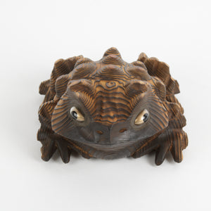 Carved Japanese toad with gold eyes