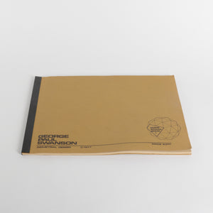 Brown soft bound book with black text and logo on a white background