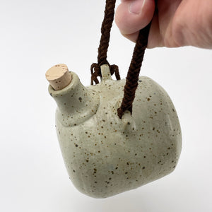 Studio pottery hanging jug with cork and braided leather strap