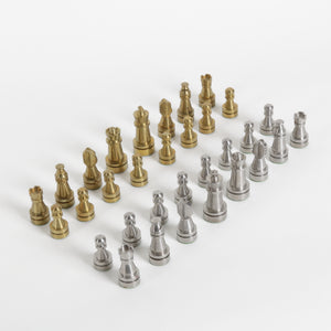 Set of gold and silver chess pieces on a white background
