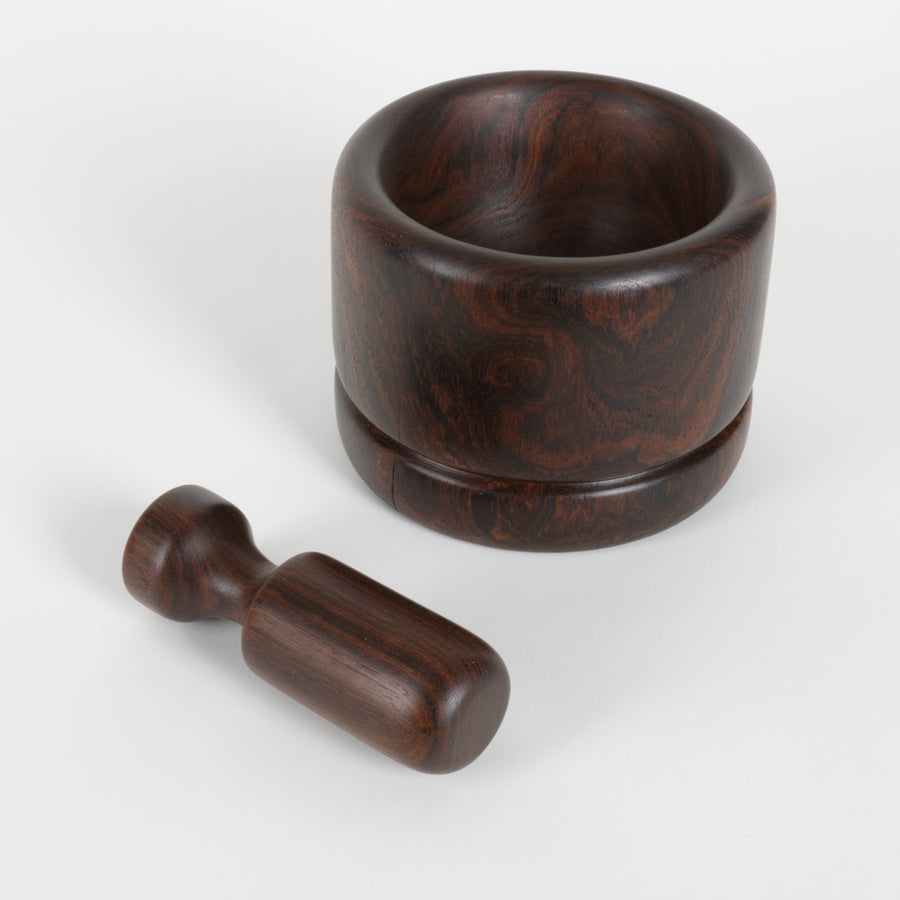 Wooden mortar and pestle on a white background