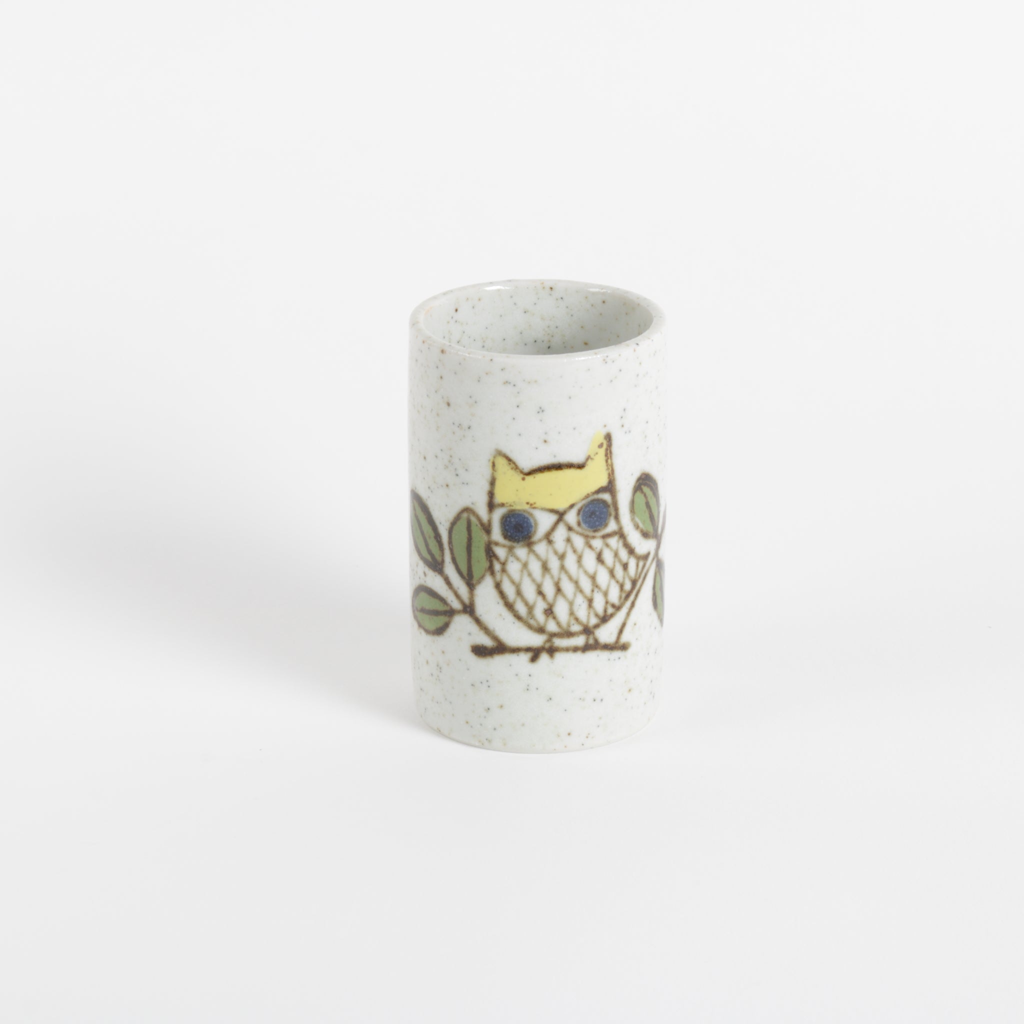 Ceramic cup with owl design on a white background