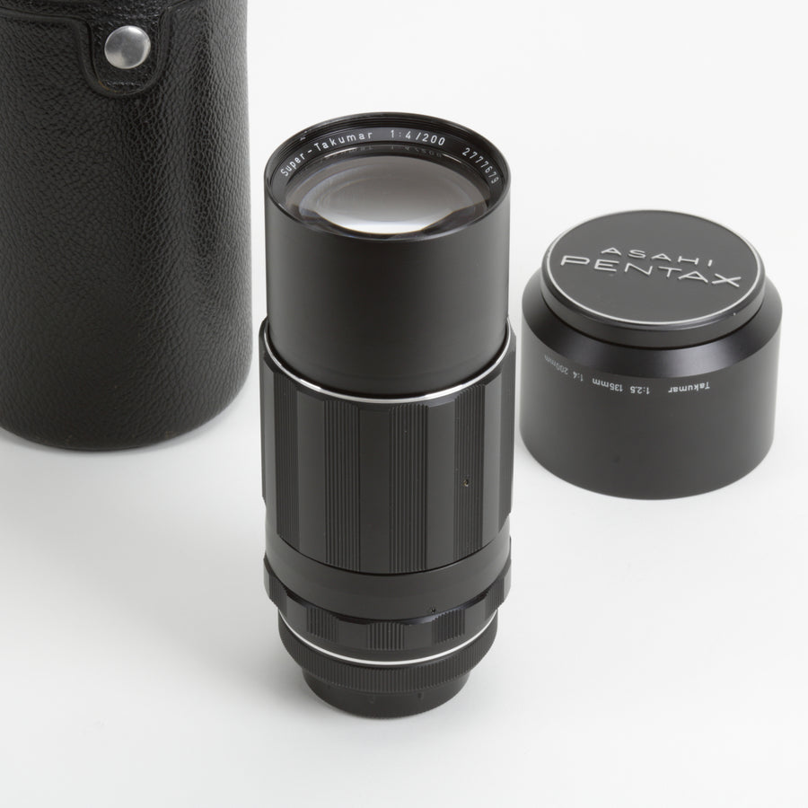 Black 200mm Takumar camera lens with Asahi Pentax branding on a white background