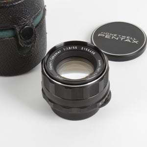 Black 55mm camera lens with Honeywell Pentax branded cap and leather case