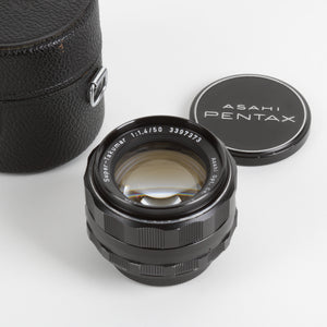 Asahi Pentax camera lens with black case and lens caps