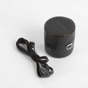 Black leather camera lens case with a strap on a white background