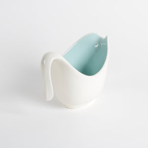 White ceramic small pitcher or creamer cup with a light aqua interior