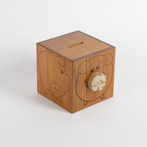 Wooden hollow teak block with pig design on a white background