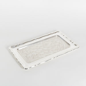 Silver rectangular tray with embossed design on a light gray background