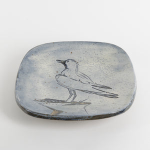 Ceramic dish with a bird design on a white background