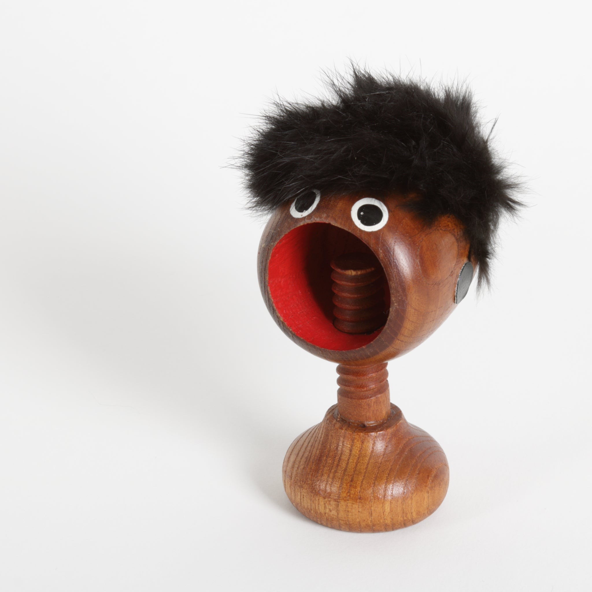 Wooden screw type nut cracker with a furry top and face and screw as a neck 