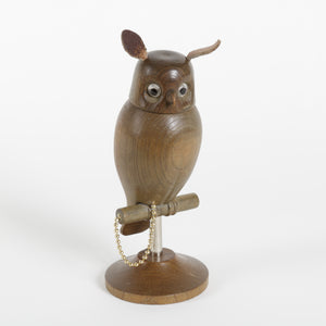 Wooden owl figurine on a white background