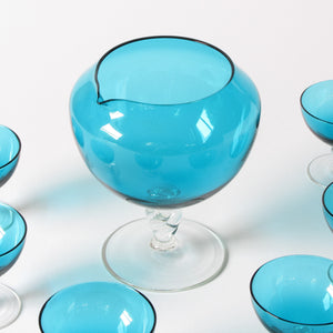Blue art glass decanter and martin glasses close up