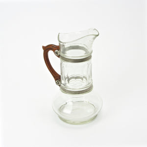 Glass pitcher with wood handle attached with metal bands