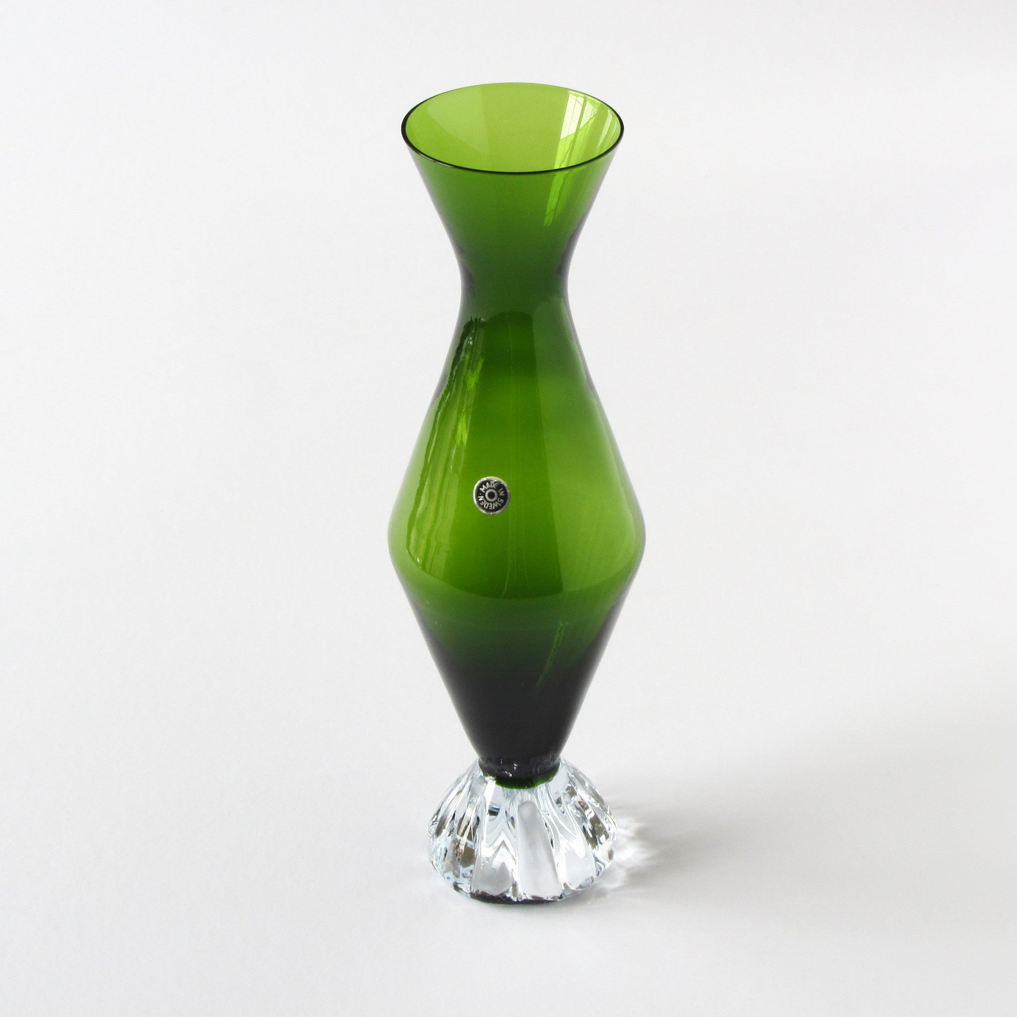 Green hour glass shaped vase with made in Sweden sticker and clear glass base