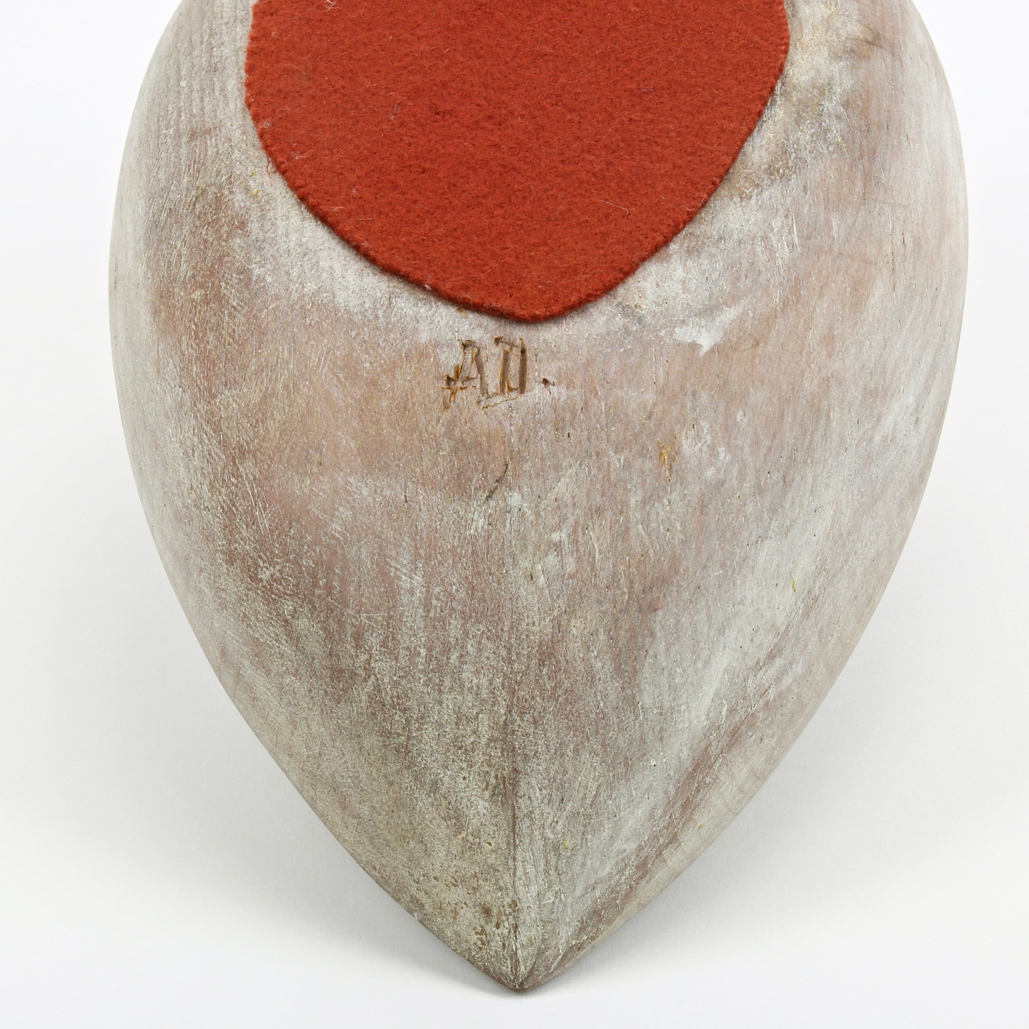 Hand carved wood quail sculpture with nail feather and felt base showing artist's initials AD