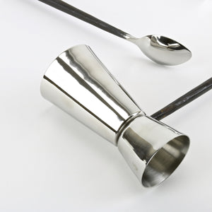 Stainless steel bar tool set with shot cups and ice tongs closeup view