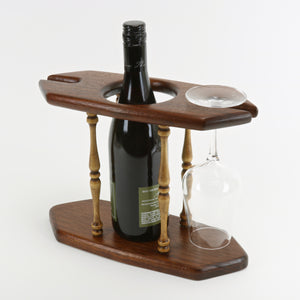 Solid teak wine caddy shown with wine bottle and glass