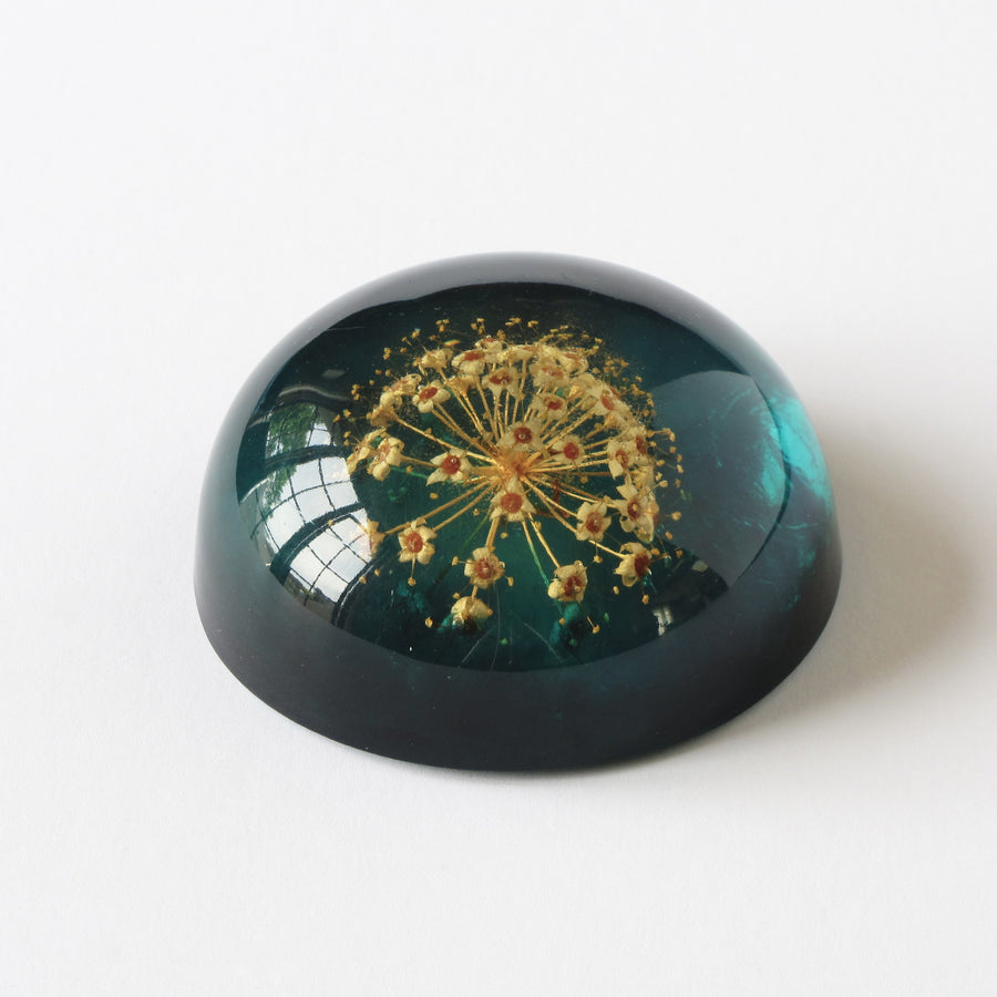 Blue acrylic Jeanne Ocker paperweight with flower