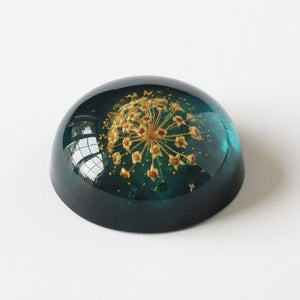 Blue acrylic Jeanne Ocker paperweight with flower