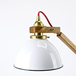 White enamel shade with brass socket on mid century oak lamp