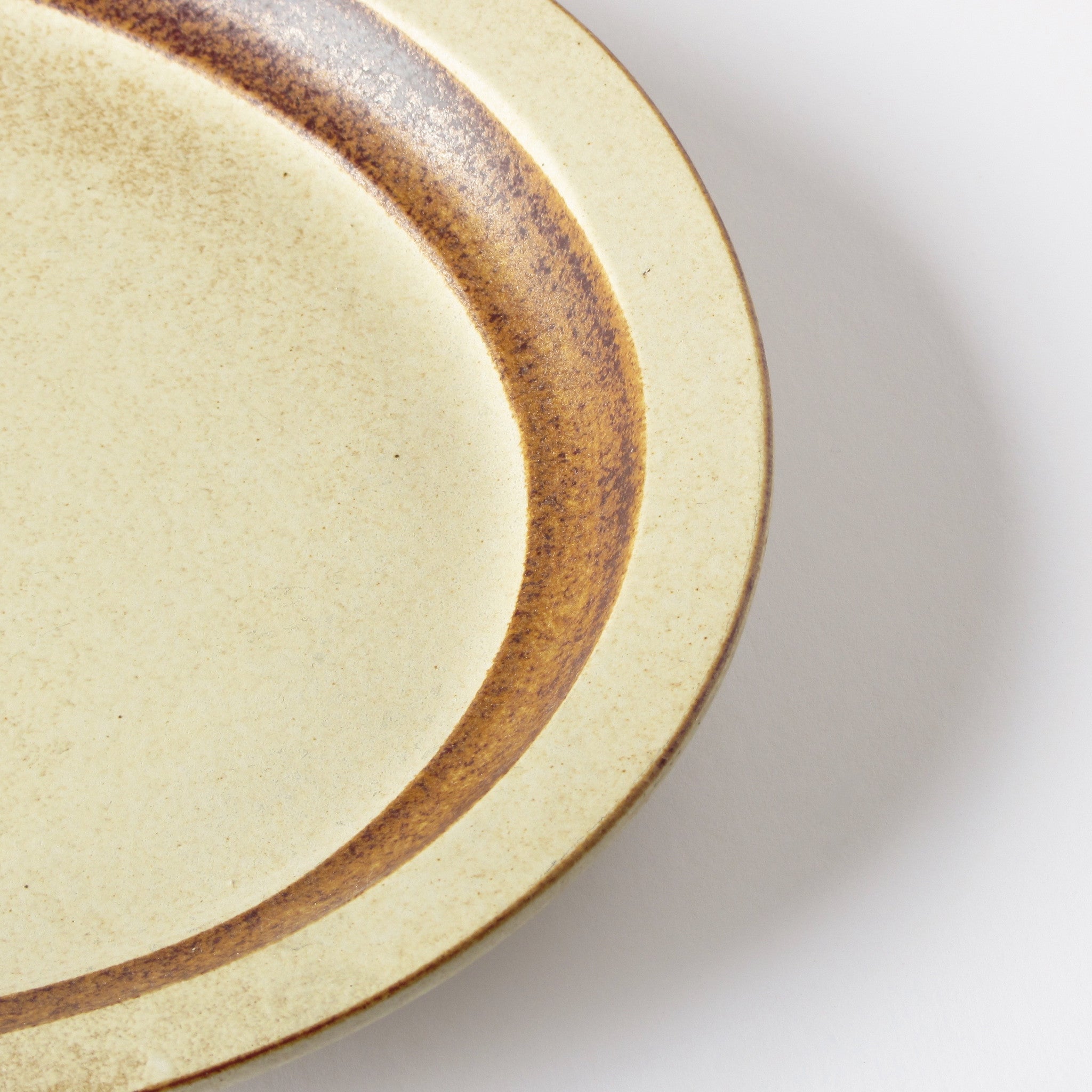 Pottery craft plate edge detail of glaze